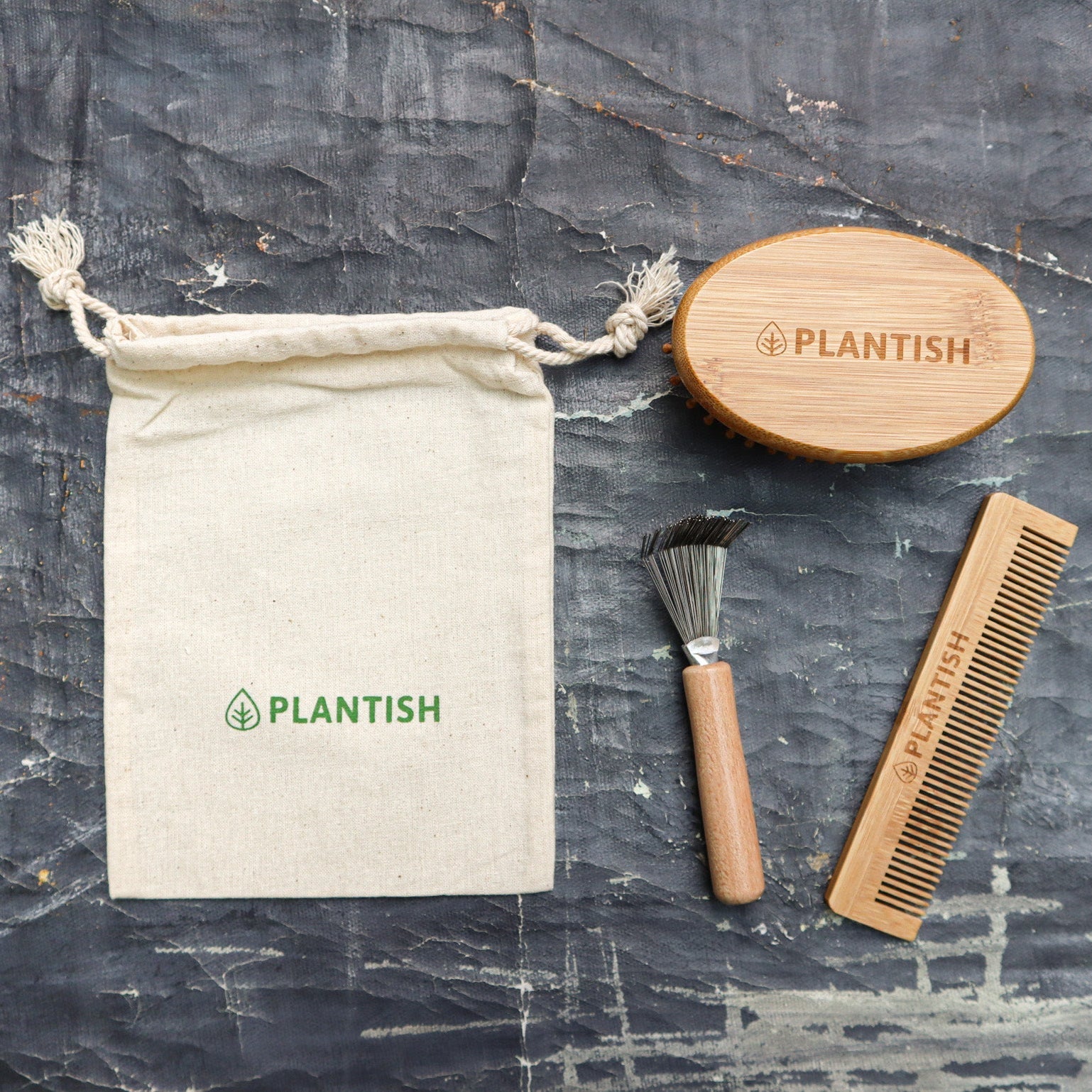 On-the-go bamboo hair brush set with detangling comb, cleaning tool, and reusable travel bag.