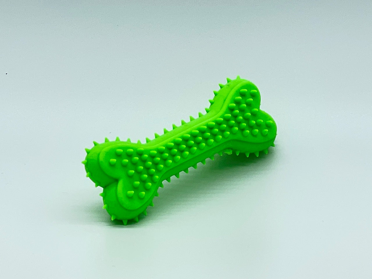 Flexible non-toxic plastic chewer bone dog toy in vibrant color for active small breeds — view 2
