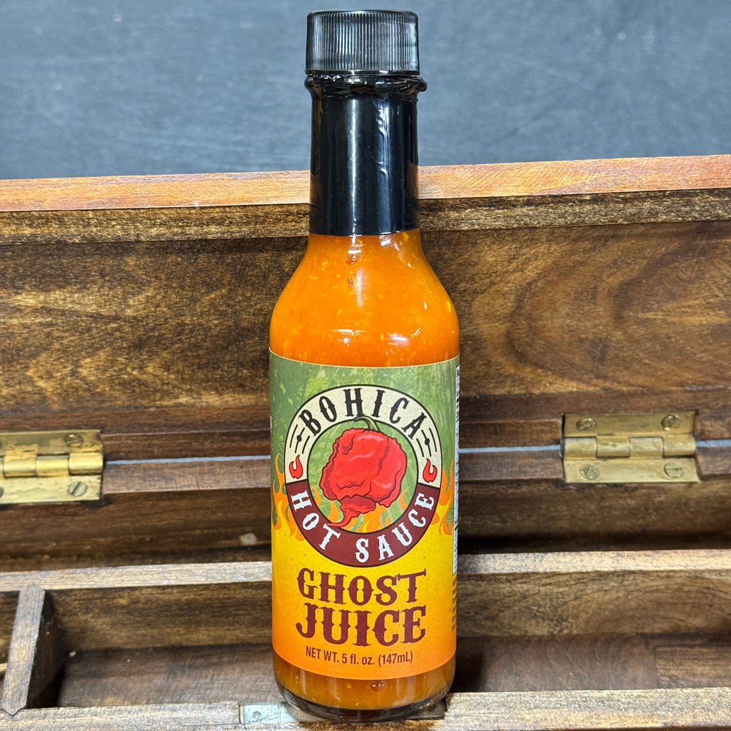 Bottle of Ghost Juice hot sauce featuring a vibrant fruity ghost pepper blend — view 3