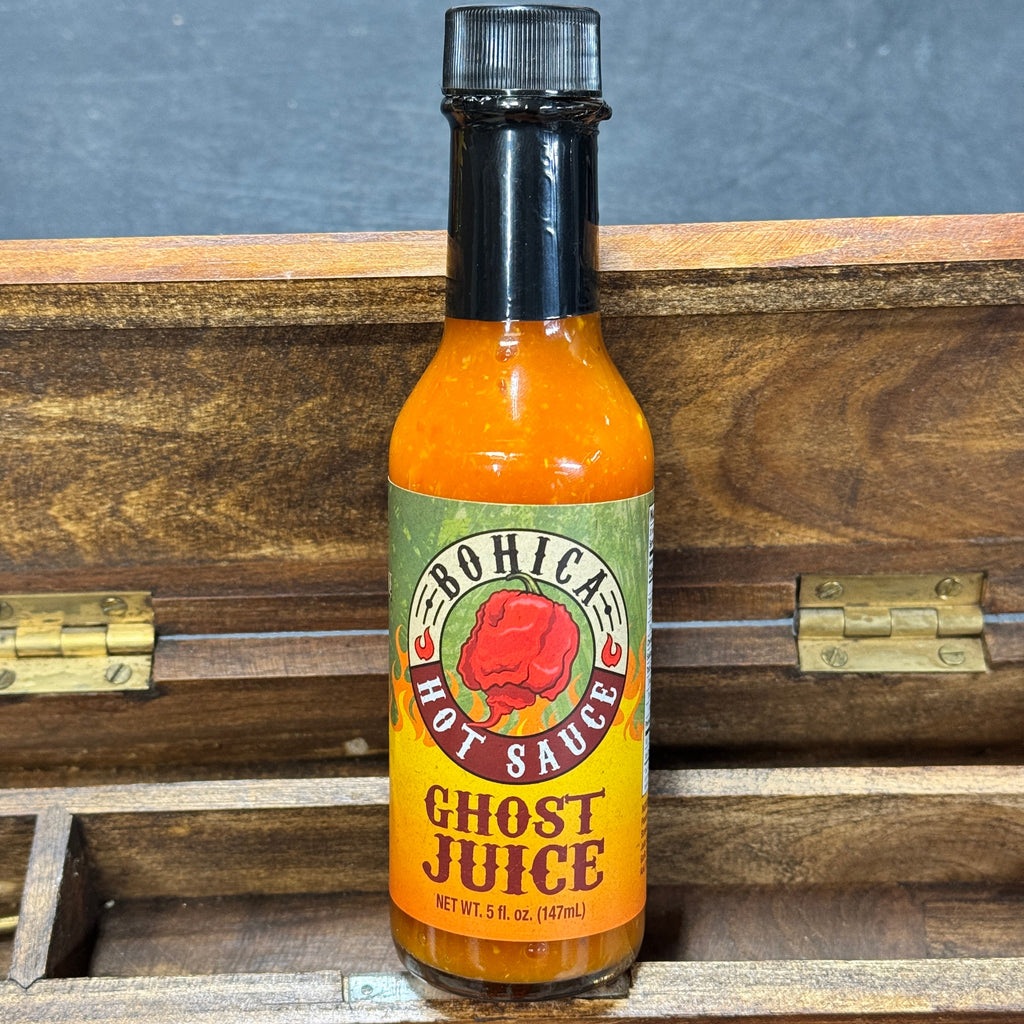 Bottle of Ghost Juice hot sauce featuring a vibrant fruity ghost pepper blend — view 4