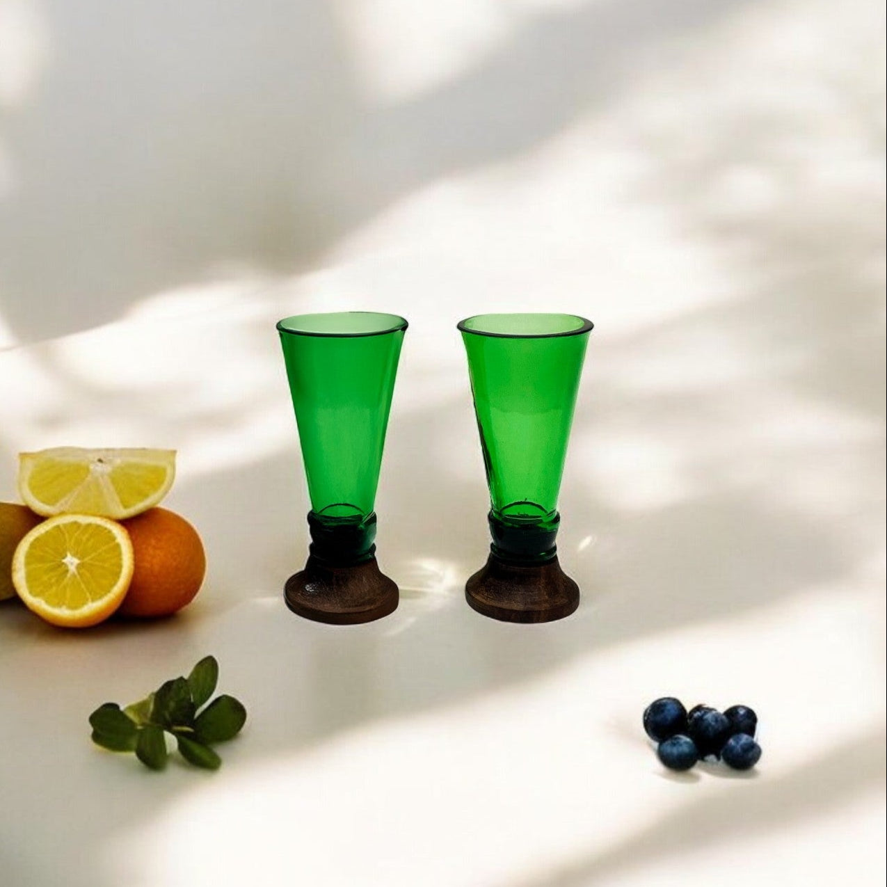 Green shot glasses made from upcycled glass bottles arranged neatly for a party setting — view 2