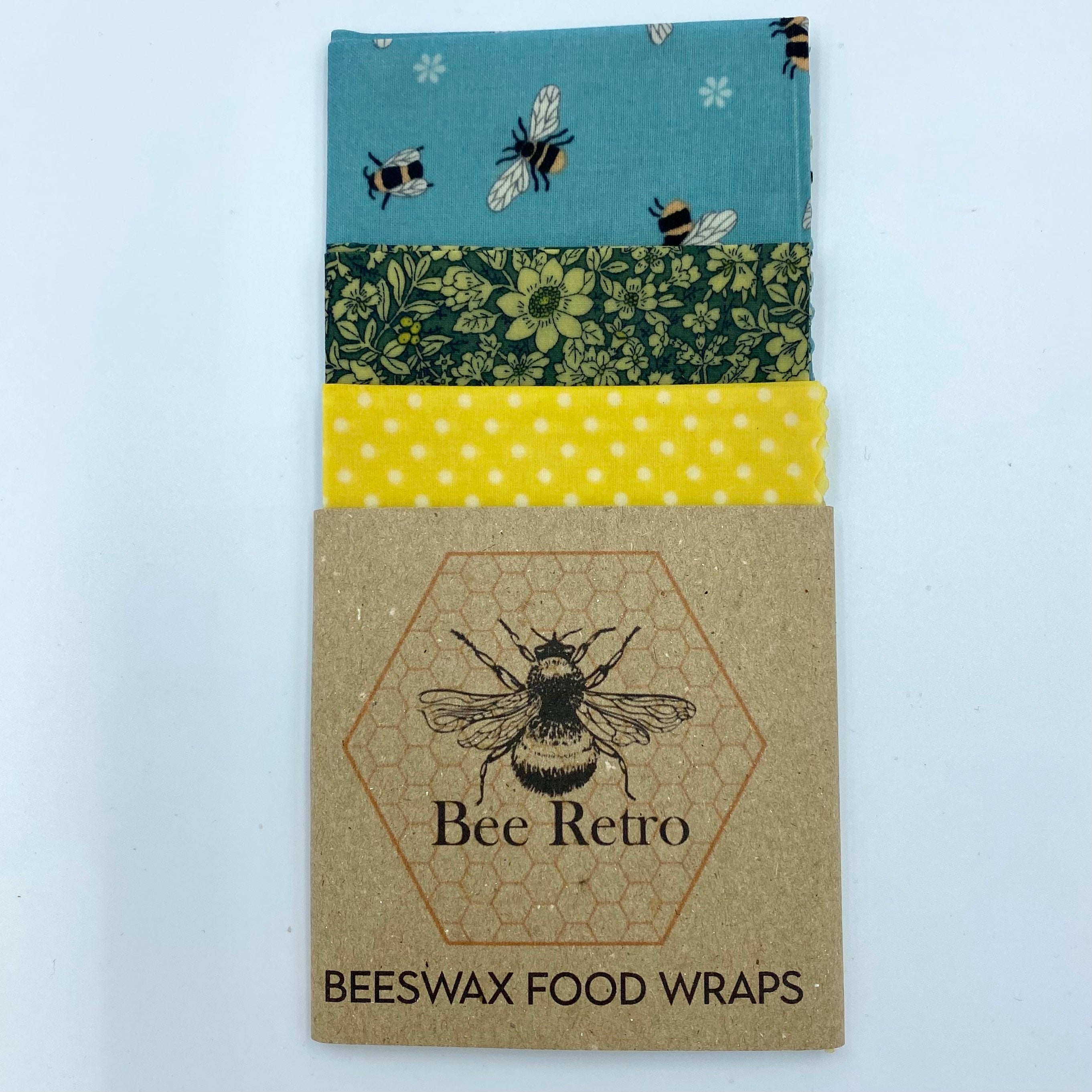 Reusable blue bee floral beeswax food wrap covering a sandwich and ceramic bowl