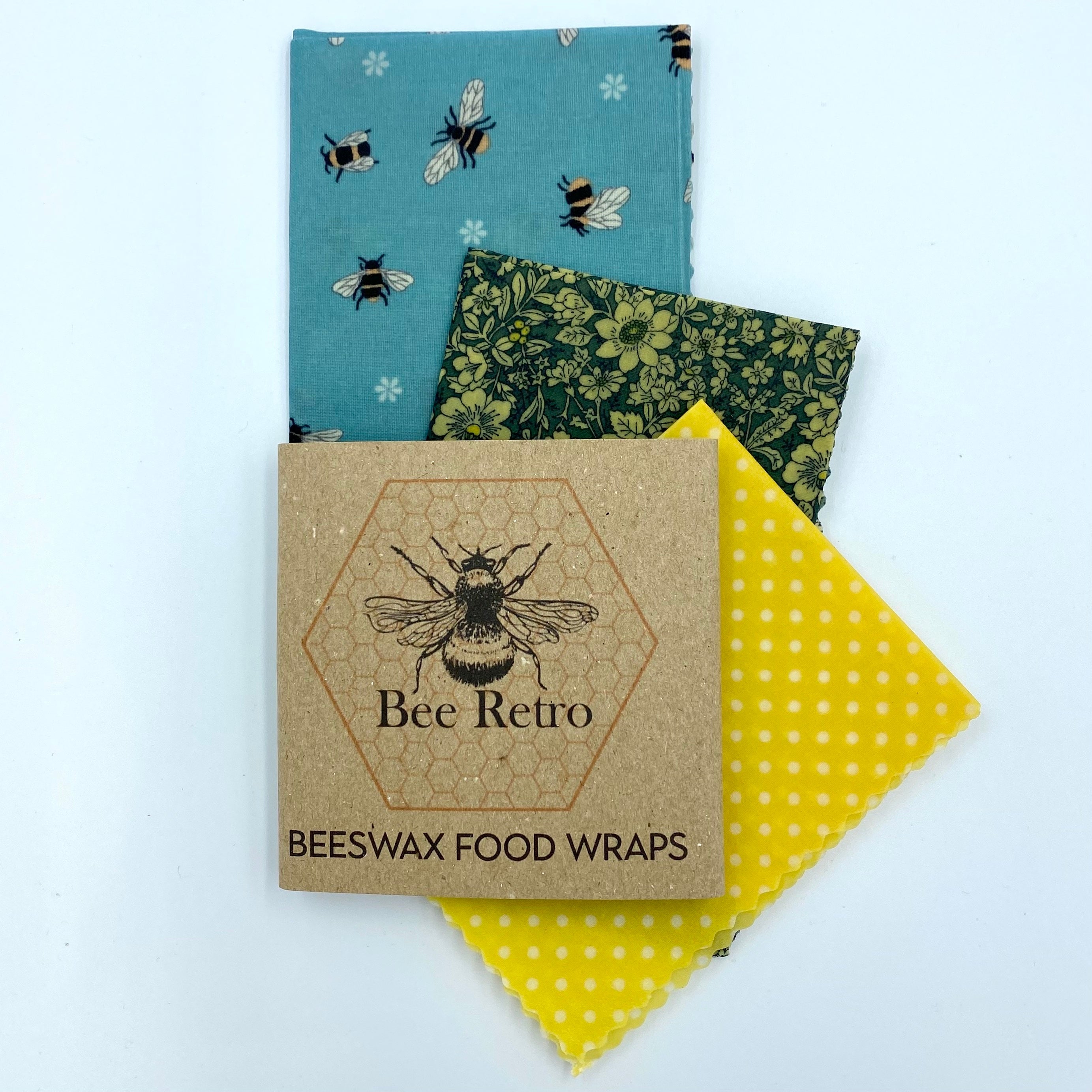 Reusable blue bee floral beeswax food wrap covering a sandwich and ceramic bowl — view 2