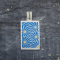 Blue Daisy compostable eco sponge with wood pulp, textured loofah, and a blue floral print pattern
