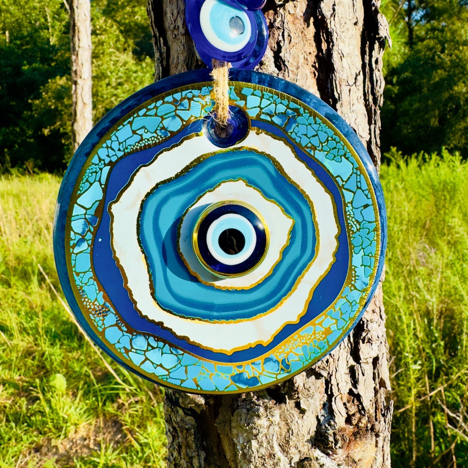 Macrame evil eye wall decor featuring a large handblown blue glass pendant and woven beads — view 3