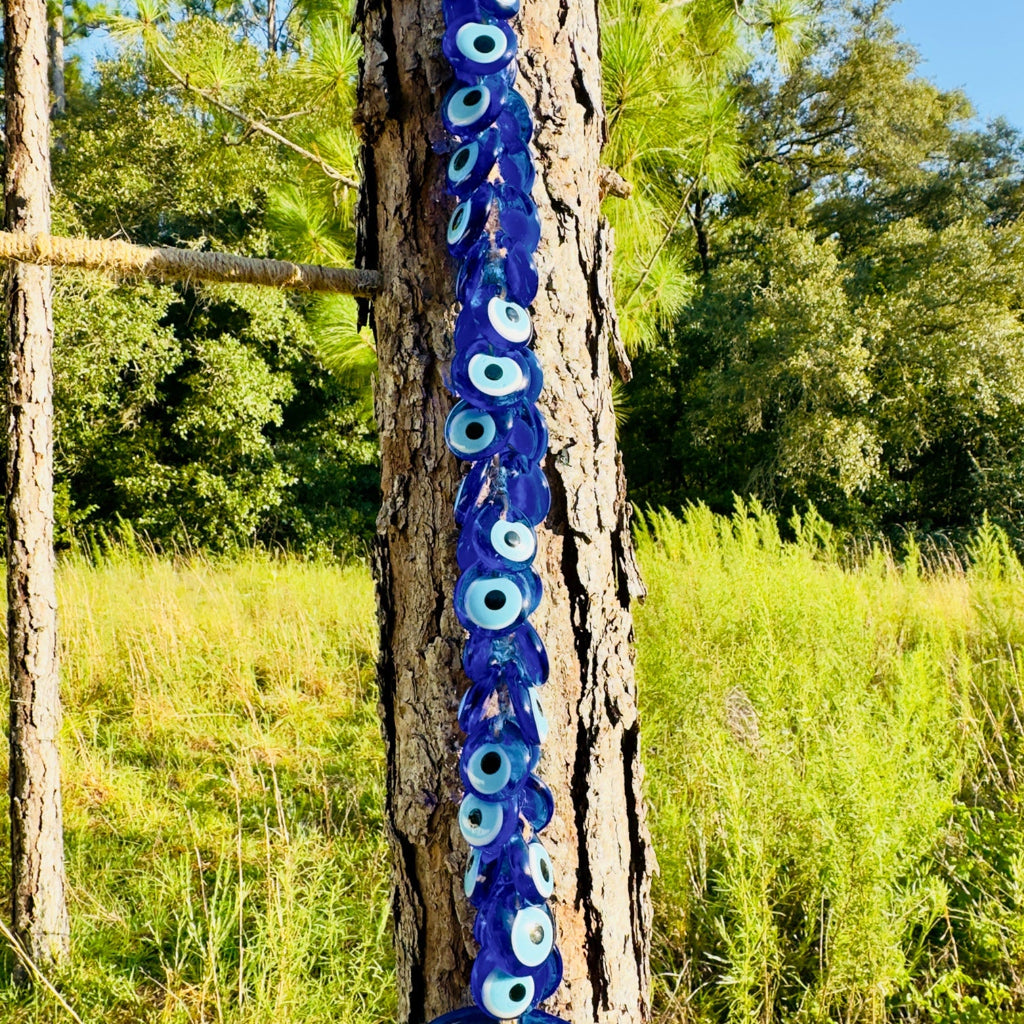 Macrame evil eye wall decor featuring a large handblown blue glass pendant and woven beads — view 4