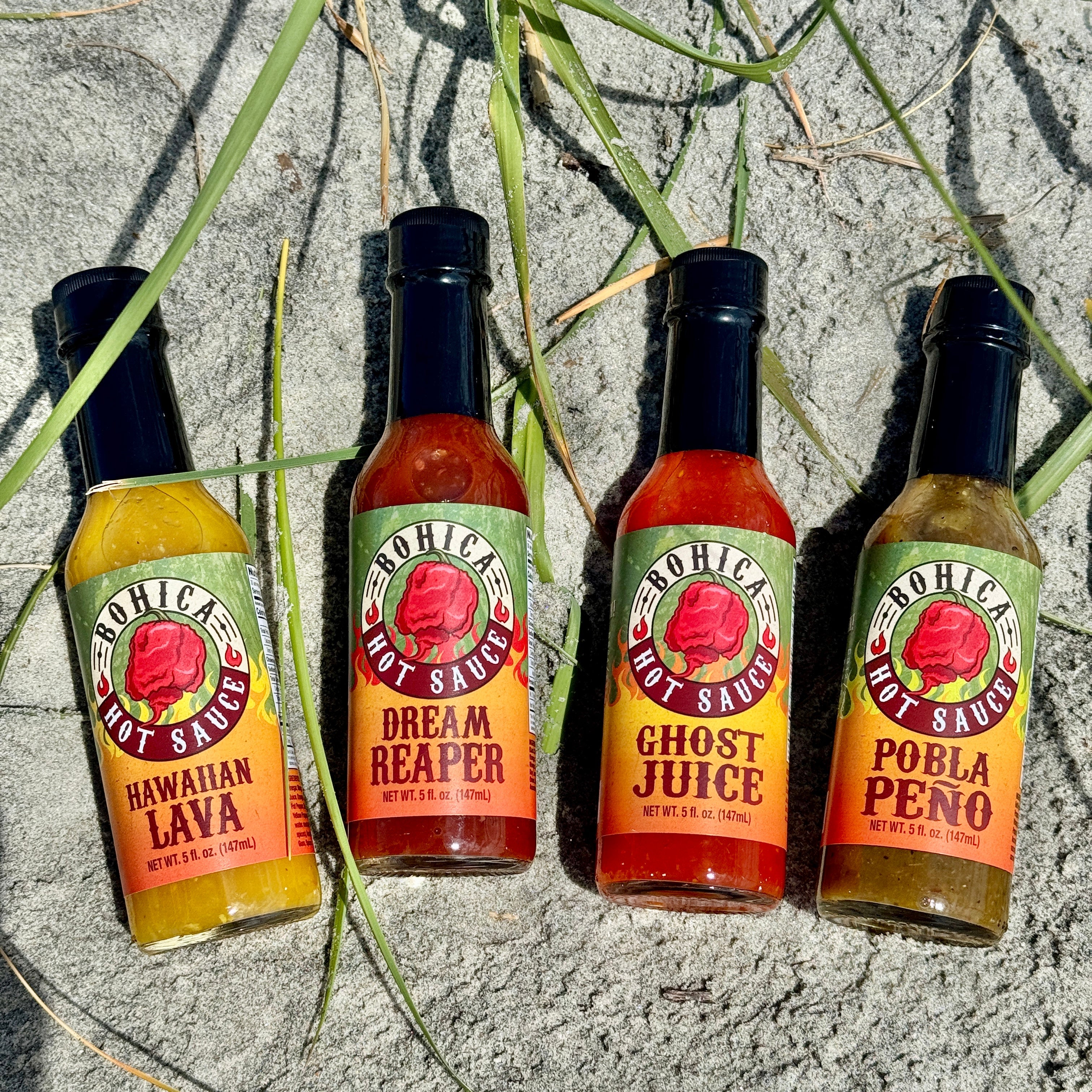 Bohica hot sauce four pack gift set featuring four glass bottles with colorful flavor labels — view 3