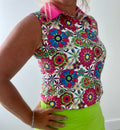 Women's sleeveless golf polo shirt featuring a button-up collar, moisture-wicking fabric, and regular fit.