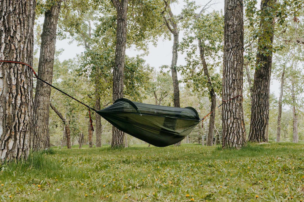 Portable camping hammock in ripstop nylon with built-in mosquito net and aluminum support poles