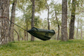 Portable camping hammock in ripstop nylon with built-in mosquito net and aluminum support poles
