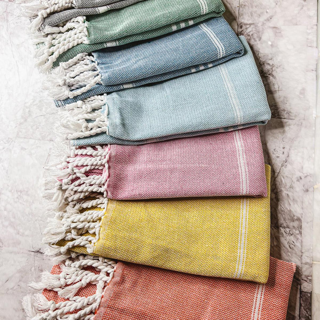 Oversized Turkish hand towel in premium cotton with natural bamboo tassels folded on a flat surface — view 2