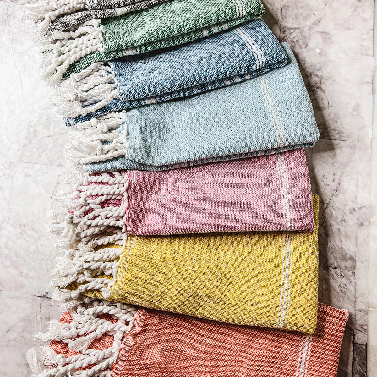 Oversized Turkish hand towel in premium cotton with natural bamboo tassels folded on a flat surface — view 2