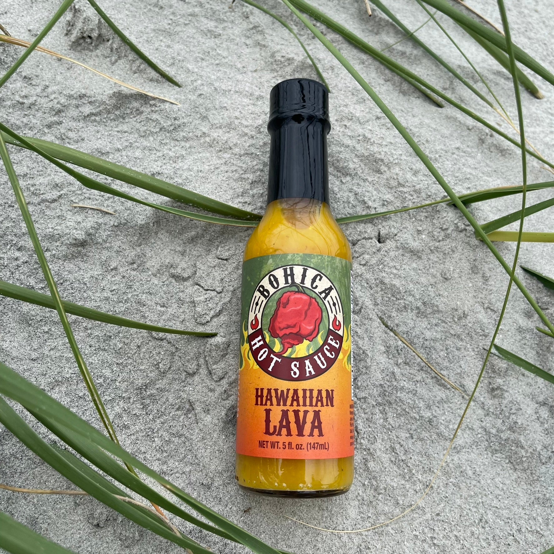 Bottle of Bohica Hawaiian Lava hot sauce with a blend of tropical fruits and spicy peppers — view 3
