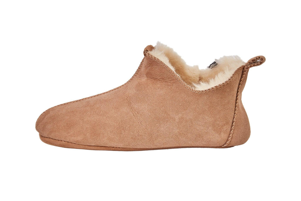 Beige adult natural sheepskin boots with genuine leather sole on a clean background — view 2