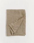 Stone washed linen tea towel folded with hemmed edges and hanging loop, premium European flax