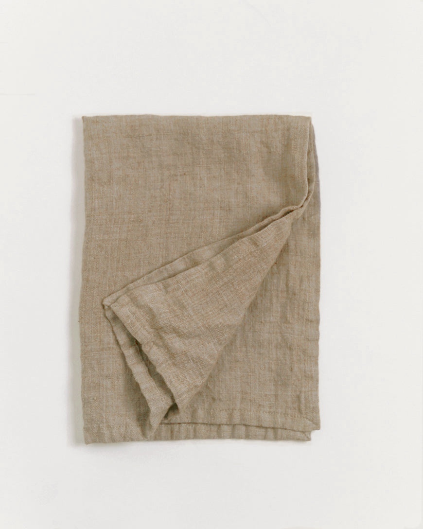 Stone washed linen tea towel folded with hemmed edges and hanging loop, premium European flax