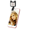 Black clip-on universal phone camera lens and selfie LED light attached to a smartphone