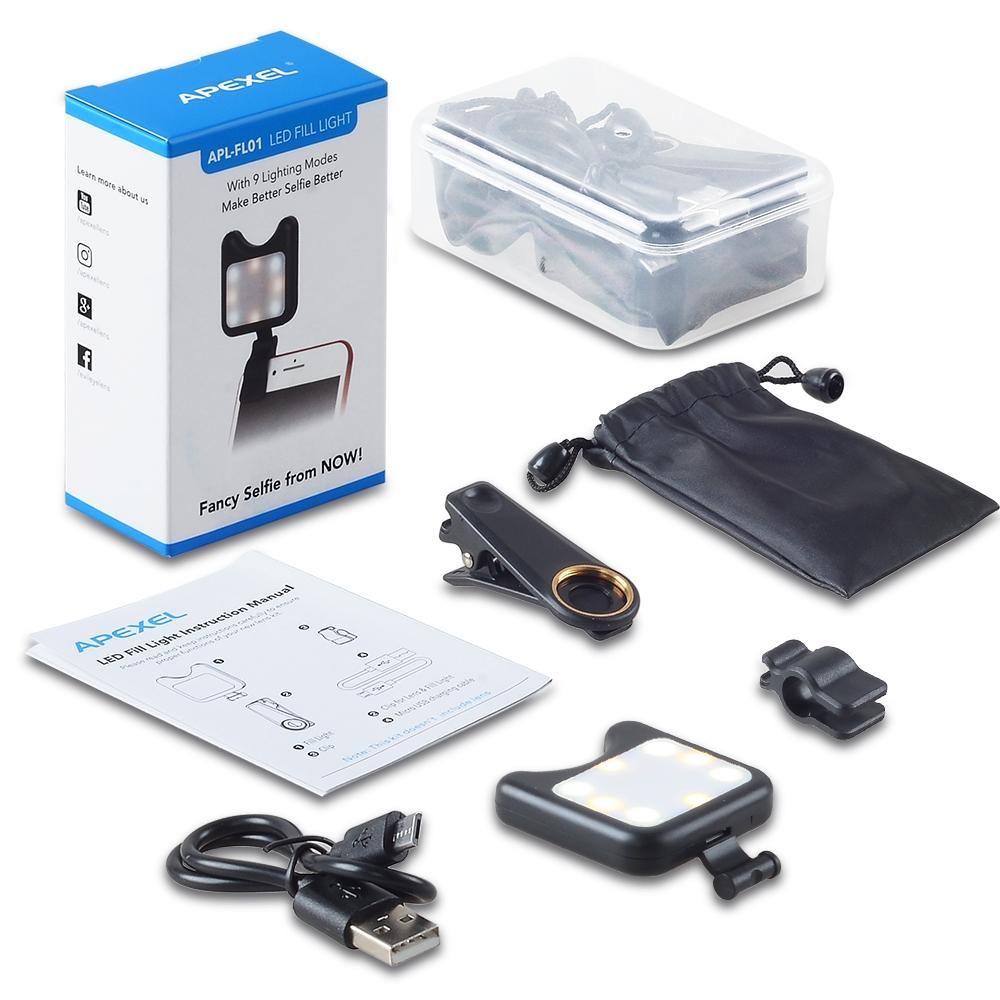 Black clip-on universal phone camera lens and selfie LED light attached to a smartphone — view 3