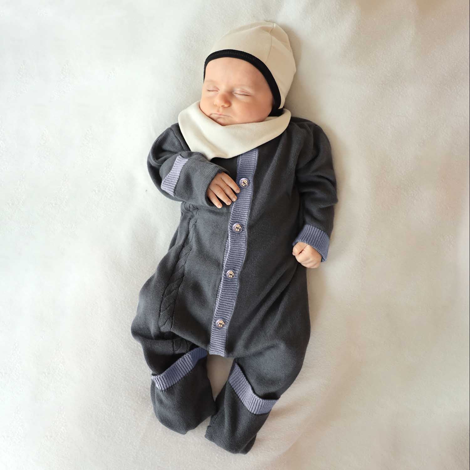 Organic cotton newborn baby romper with cable knit details, foldable cuffs, and natural coconut buttons — view 2