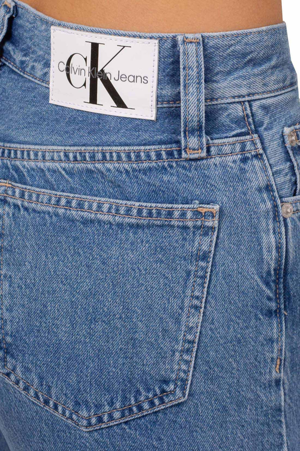 Women's medium-light wash bootcut jeans with five pocket design and logo details