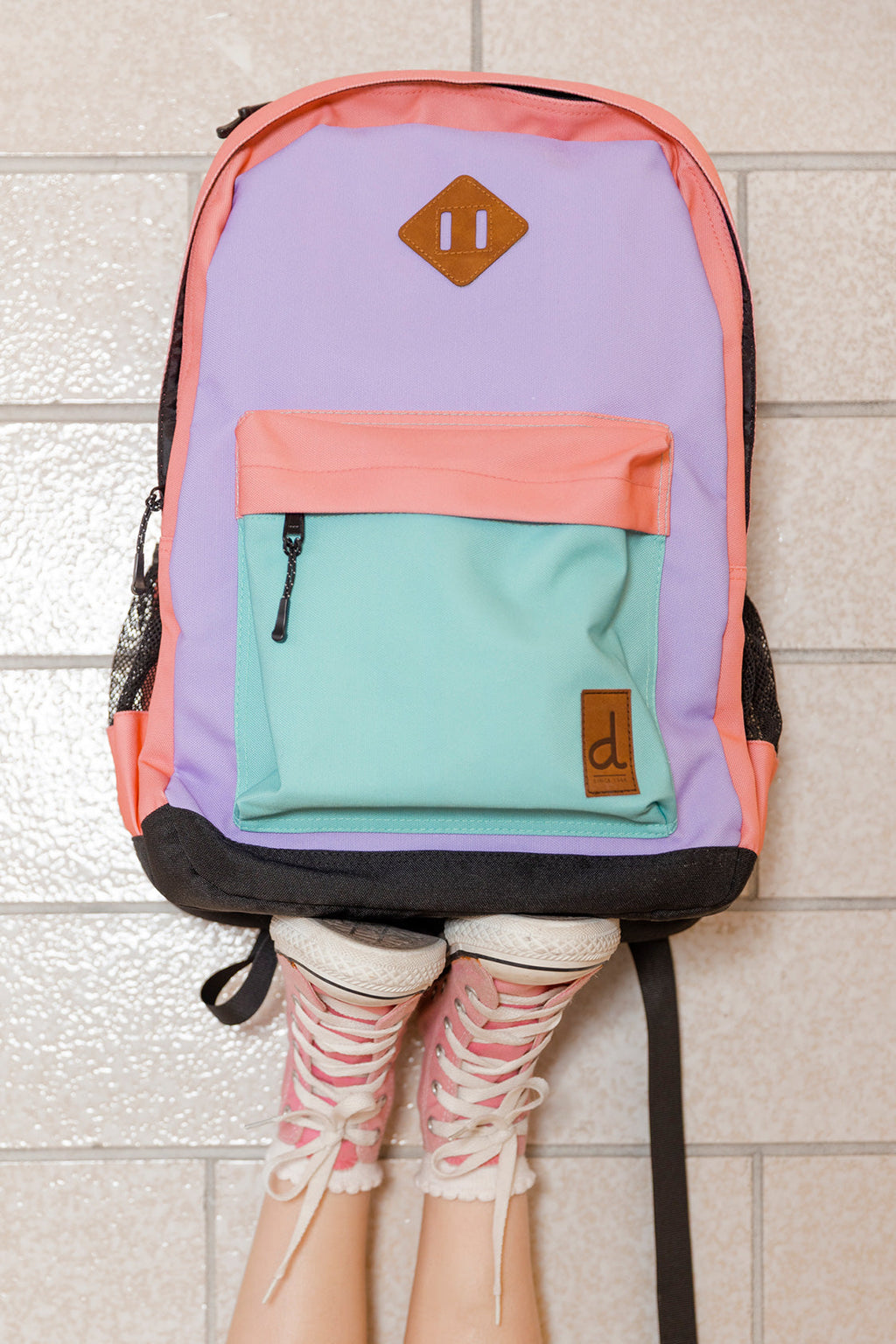 Kids color-block backpack in lavender turquoise and orange with front zipper pocket and padded straps — view 2