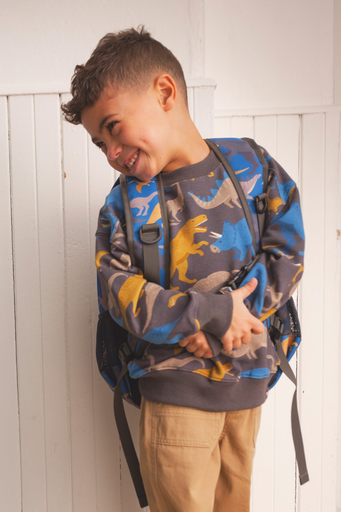 Kids backpack featuring blue dinosaur print padded straps and water bottle pocket in recycled polyester — view 2