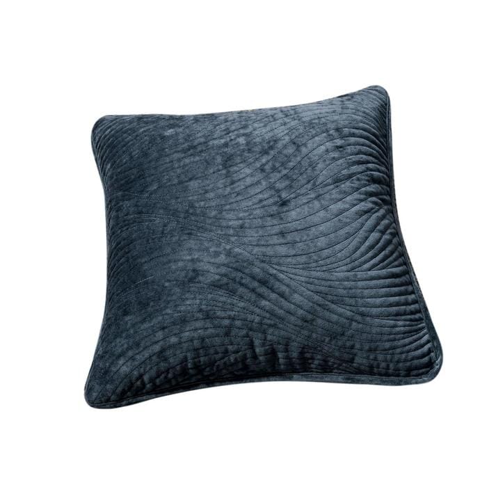 Navy blue velvet cushion cover with wavy matelassé stitching shown styled on a bedroom bed. — view 2