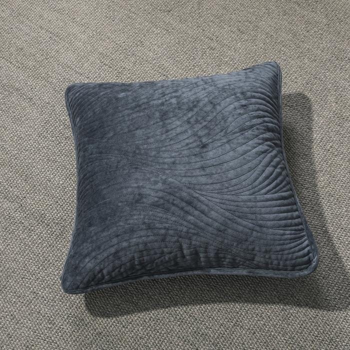 Navy blue velvet cushion cover with wavy matelassé stitching shown styled on a bedroom bed. — view 4
