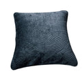 Navy blue velvet cushion cover with wavy matelassé stitching shown styled on a bedroom bed.