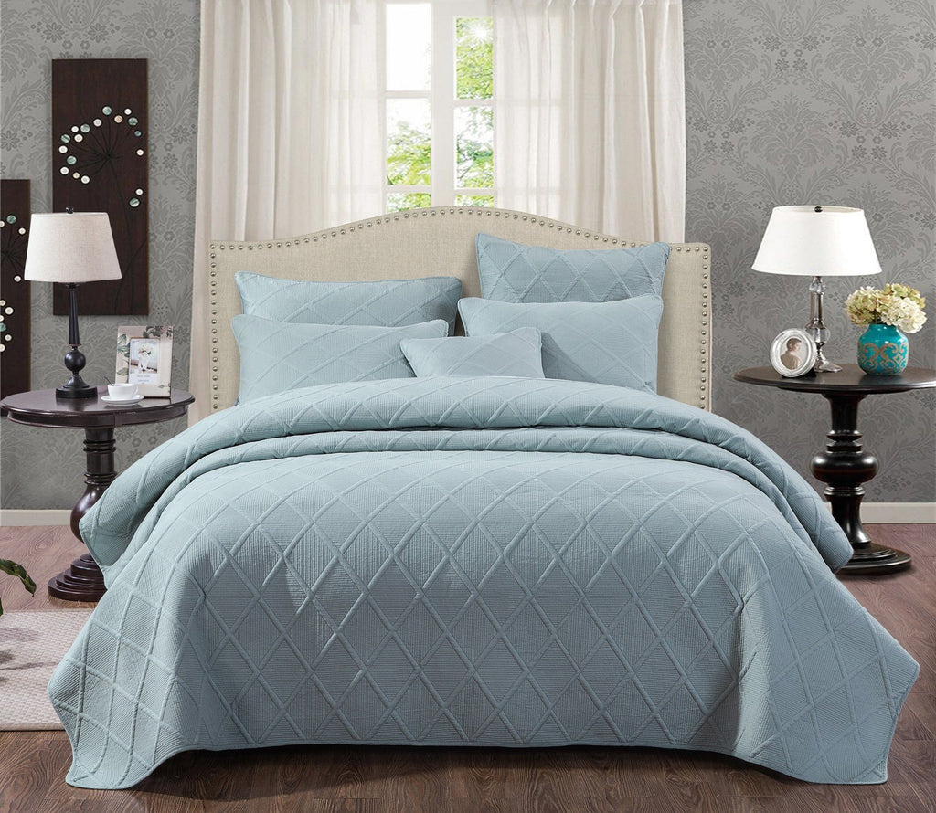 Seafoam blue cotton diamond pillow sham with geometric matelasse stitching on a modern bed setup — view 5