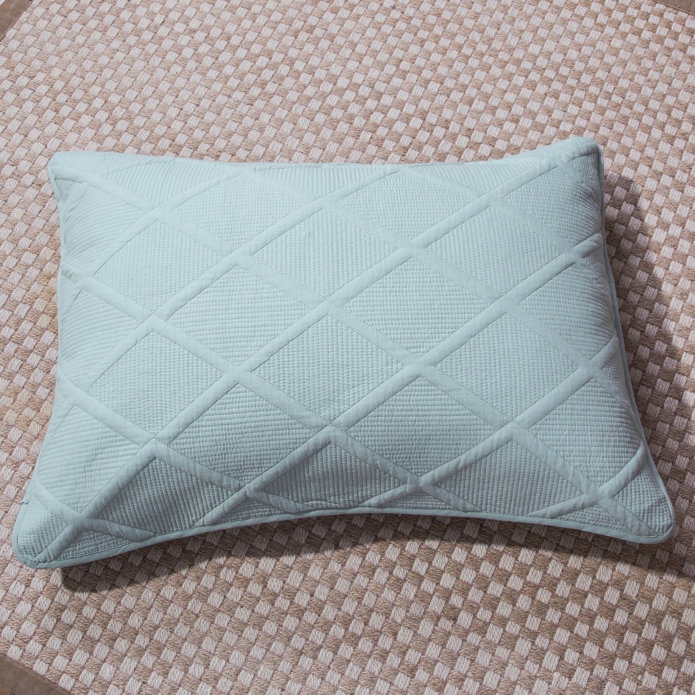 Seafoam blue cotton diamond pillow sham with geometric matelasse stitching on a modern bed setup — view 3