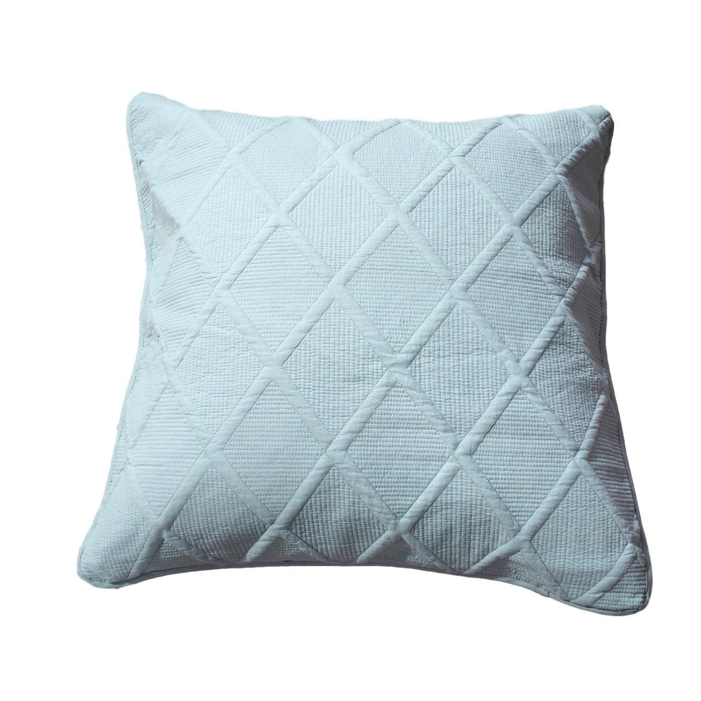 Seafoam blue cotton cushion cover with geometric diamond matelasse stitching on a comfortable bed