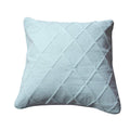 Seafoam blue cotton cushion cover with geometric diamond matelasse stitching on a comfortable bed
