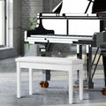 Black solid wood piano bench with padded PU leather seat and internal storage compartment.