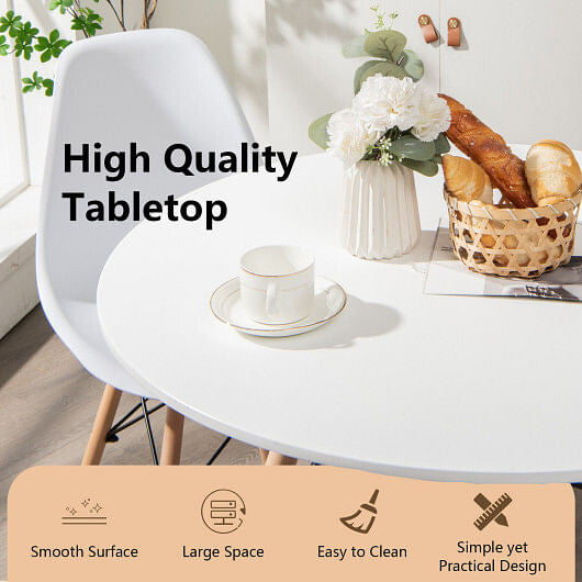 White round modern dining table with solid beech wood legs on a clean hardwood floor — view 4