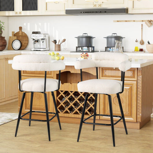 Two white boucle swivel bar stools with curved backs, armrests, and metal frames