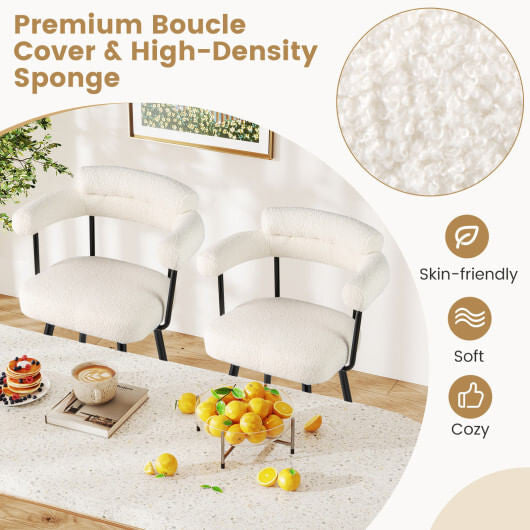 Two white boucle swivel bar stools with curved backs, armrests, and metal frames — view 4