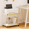 White two-tier mobile side table with golden trim, open shelves, and rolling casters