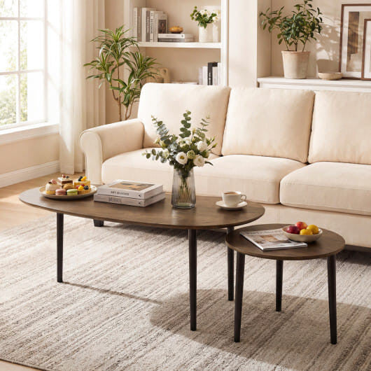 Two mid century walnut finish nesting tables with rounded edges and solid rubber wood legs