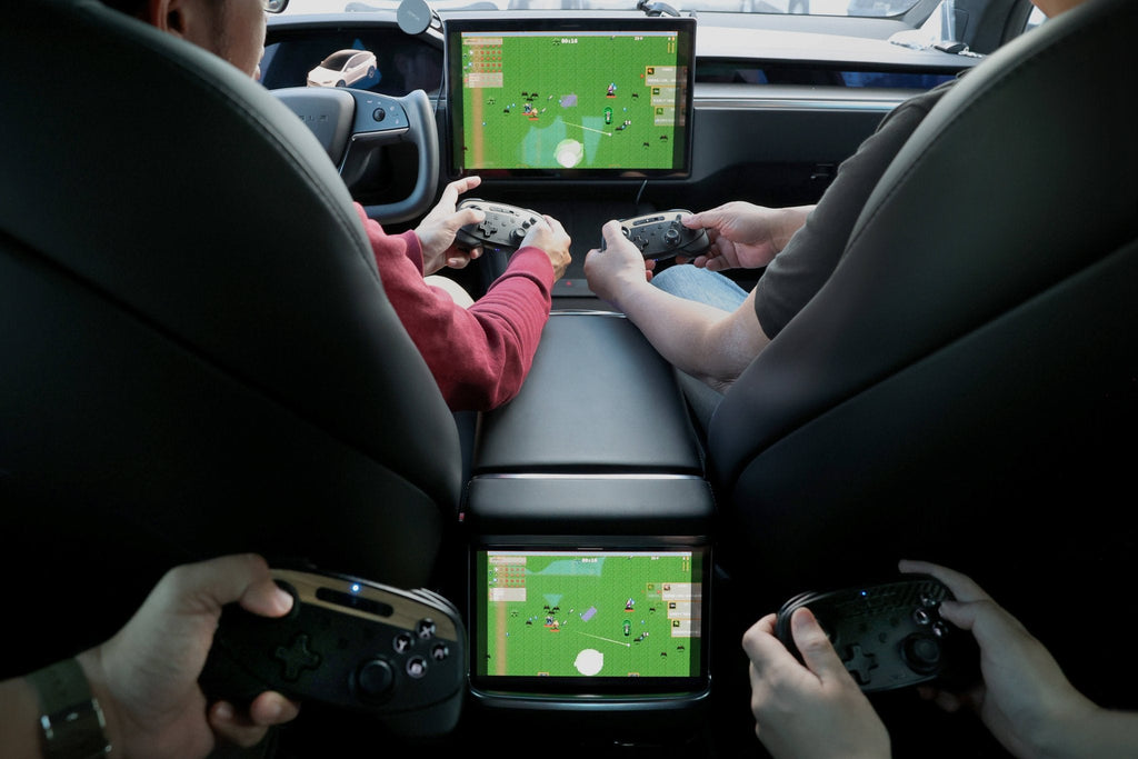 Black multi-device wireless gaming controller for Tesla with dual joysticks and wireless charging capability — view 4
