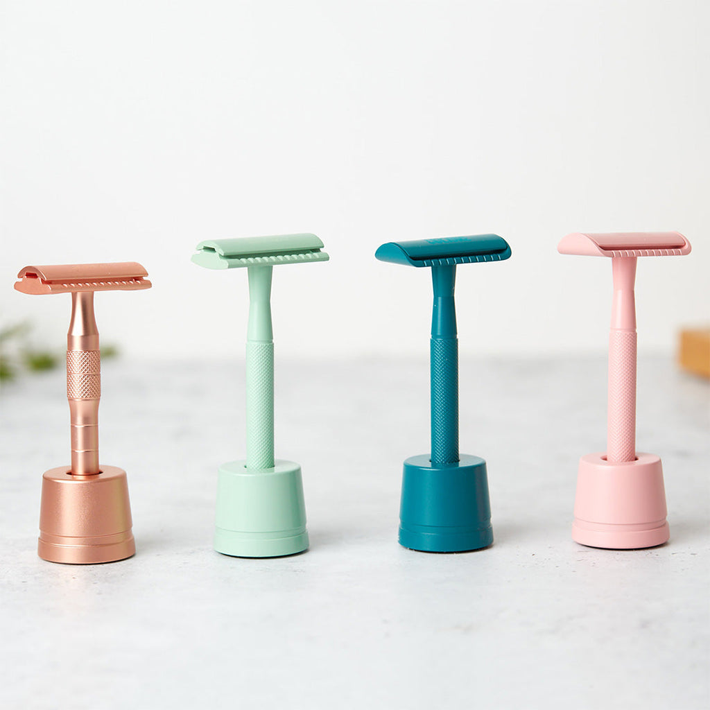 Premium weighted safety razor stand in a matching metallic finish for an organized bathroom vanity.