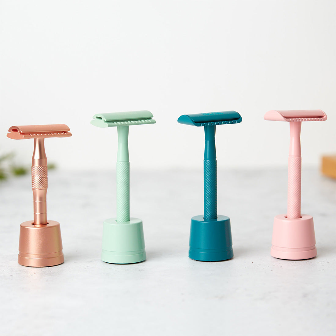 Premium weighted safety razor stand in a matching metallic finish for an organized bathroom vanity.