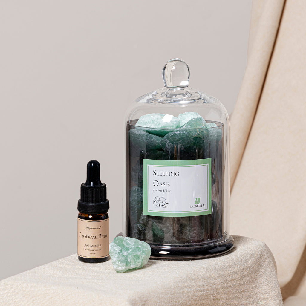 Sleeping Oasis gemstone diffuser with natural stones and Tropical Bath fragrance oil bottle. — view 3