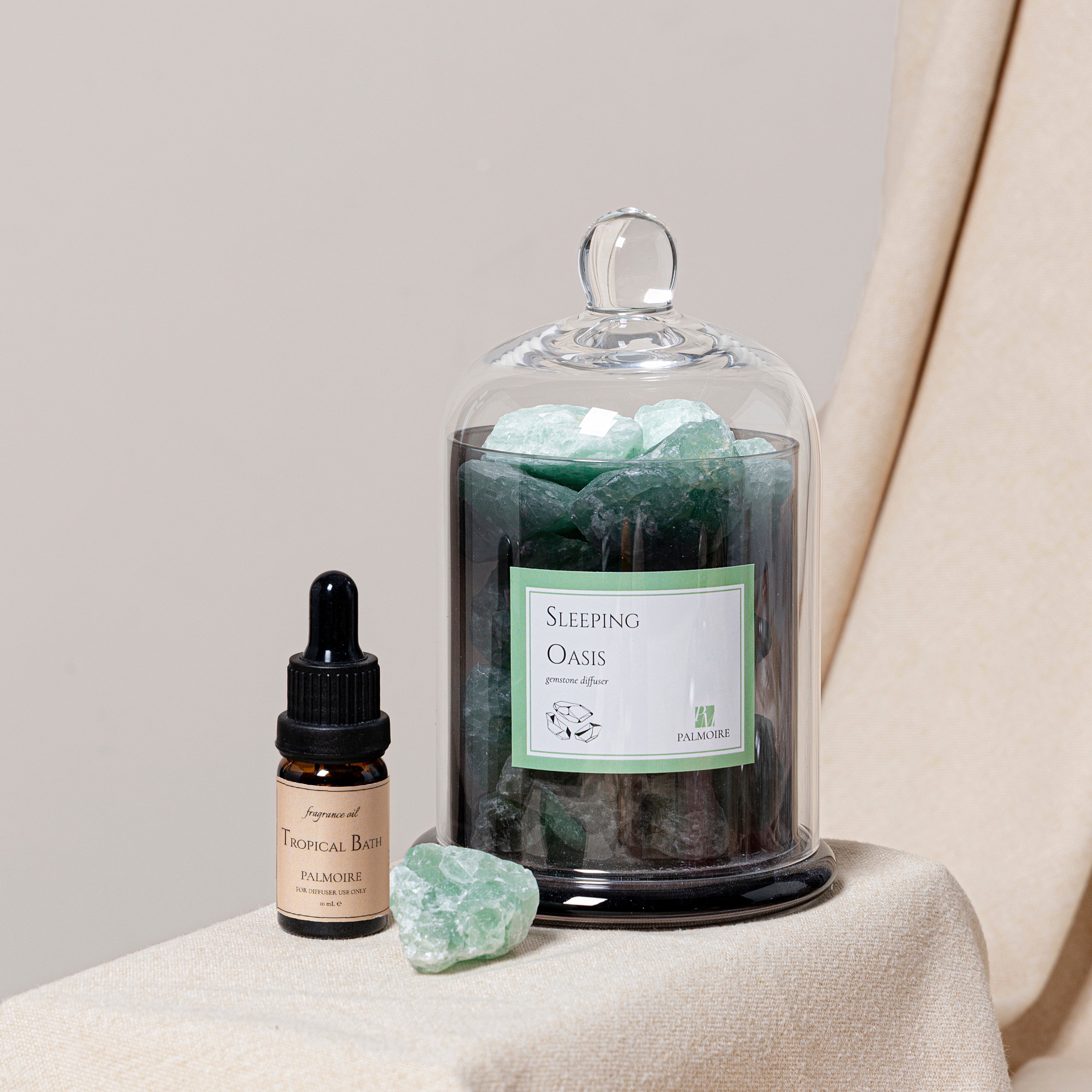 Sleeping Oasis gemstone diffuser with natural stones and Tropical Bath fragrance oil bottle. — view 3