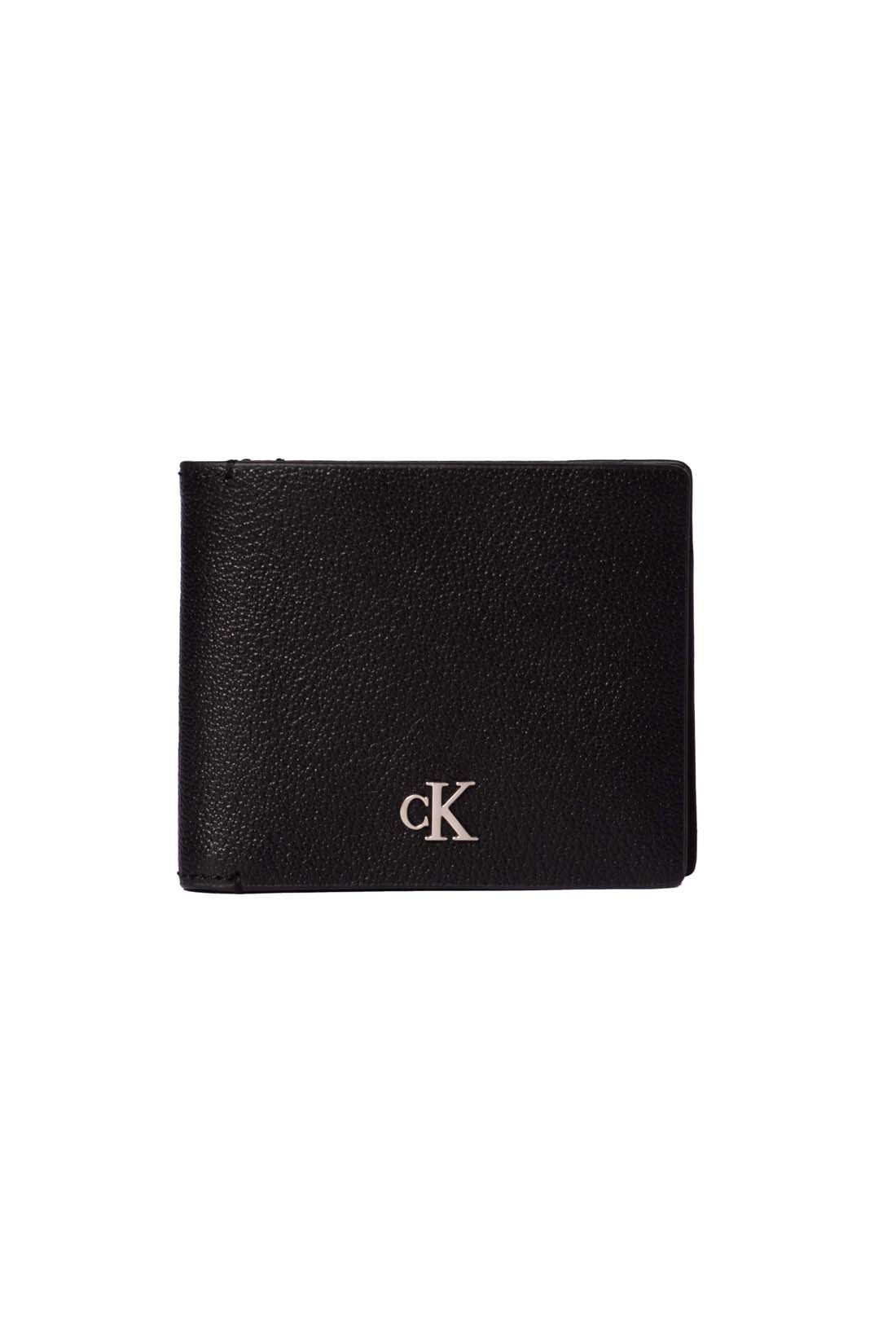 Black leather men's bifold wallet with monogram plaquette, card slots, and snap coin pocket. — view 4