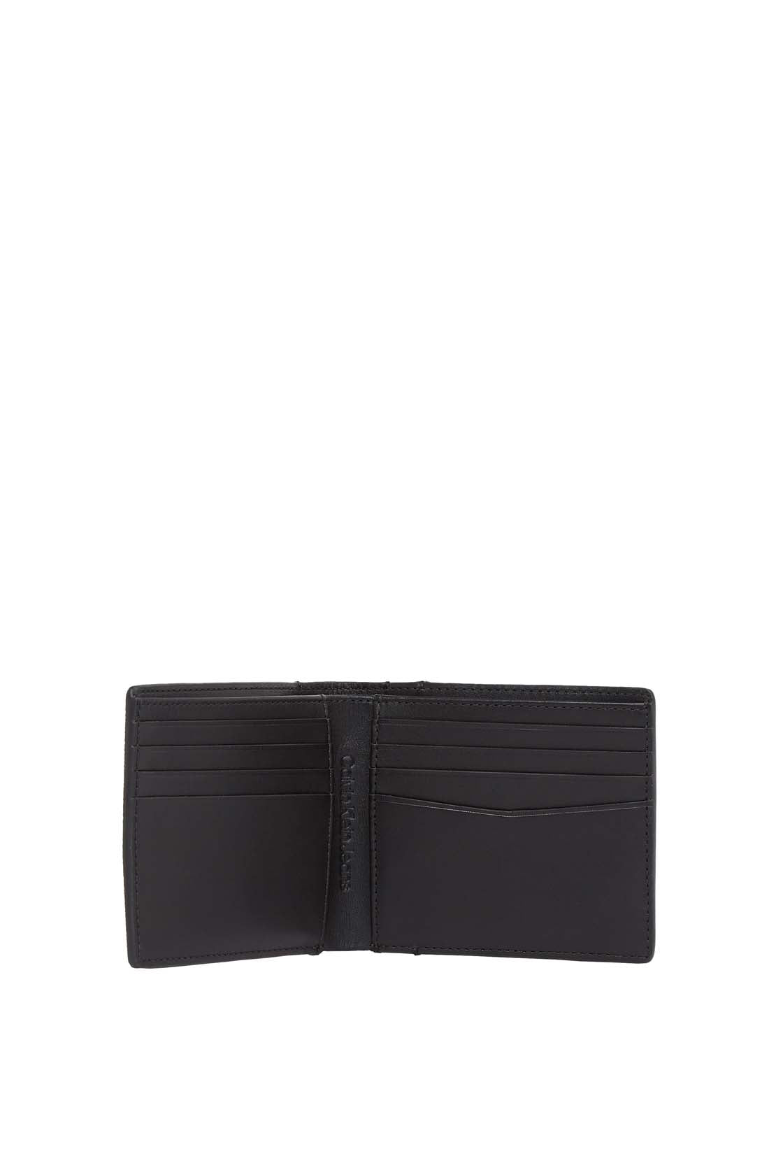 Men's bifold wallet in grained black leather with interior compartments and signature embossed monogram logo. — view 6