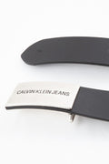 Women's black genuine leather belt featuring a silver metal logo plaque and snap closure.