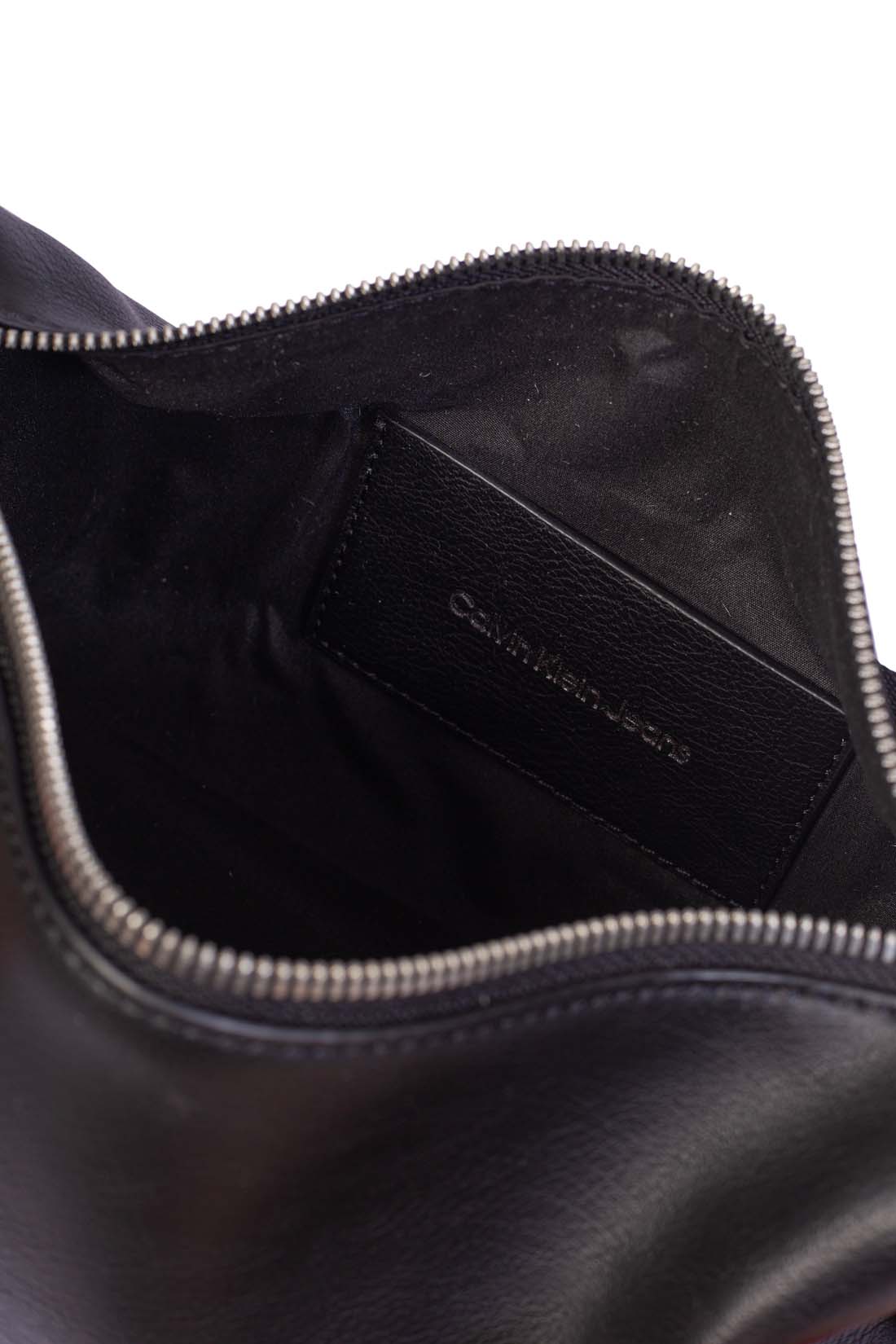 Black faux leather Calvin Klein shoulder bag with adjustable printed monogram strap and logo details