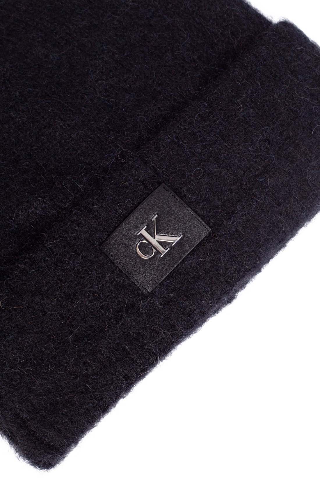 Women's purple alpaca wool blend beanie with adjustable turn-up cuff and front monogram patch — view 4
