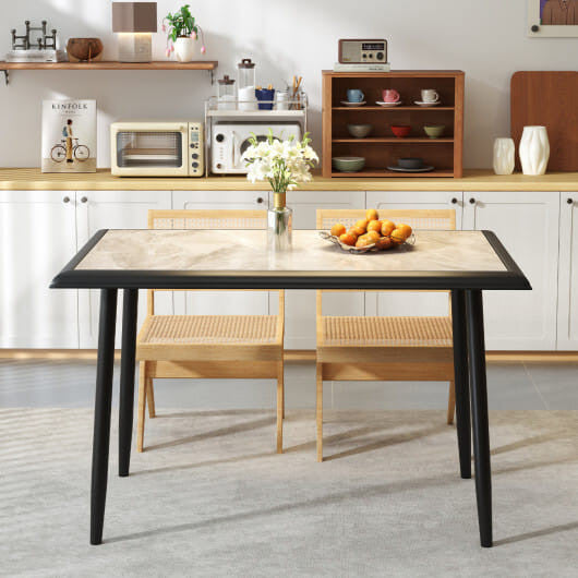 Modern 44-inch faux marble sintered stone dining table with a gold x-shaped metal frame.